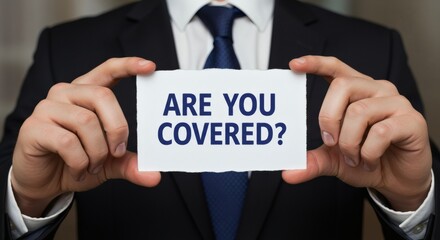 Insurance Offer Man in Suit Asks Are You Covered with a Sign.