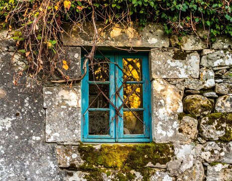 Old stone wall with a vintage teal window - Powered by Adobe