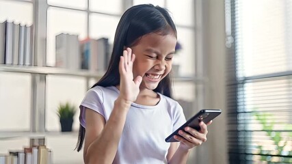 A young asian girl using a smartphone for education and learning at home, showcasing the integration of technology in childrens development and future opportunities - Powered by Adobe