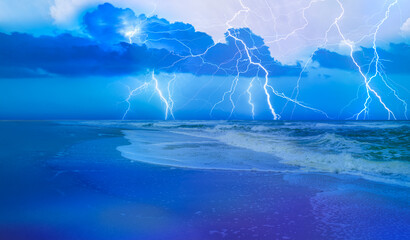 Thunderstorm over storm waves on the sea with dramatic clouds