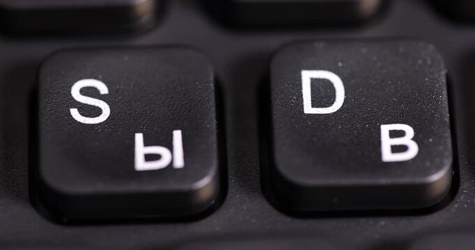 keyboard with Russian and English letters in white, bilingual computer keyboard layout with Latin and Cyrillic alphabet