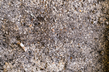 Toxic cigarette ash fills the surface of a dirty ashtray, with charred remnants and filter tips scattered, highlighting the harmful residue left by smoking.