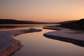 stunning salt lake in tunisia during soft twilight framed by natural curves of landscape