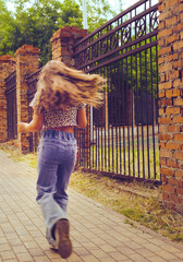 Young girl enjoying walking in blurred motion effect photography. City life. Freedom and carefree....