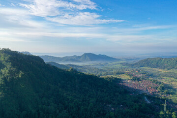 Forest-Covered Mountain Slopes Casting Shadows Over the Valley