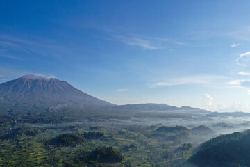 Misty Morning Over Rice Fields and Mount Agung Volcano