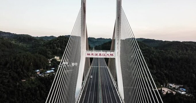 Wujiang Bridge spans scenic mountains showcasing modern engineering and picturesque surroundings during sunset