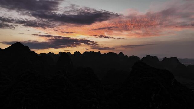 Explore breathtaking aerial views of sunrise over Wanfenglin in Xingyi City, Guizhou Province