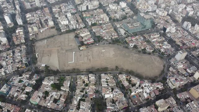 Aerial view of huaca pucllana, a pre inca archaeological site located in the miraflores district of lima, peru, showcasing the contrast between ancient ruins and modern urban development