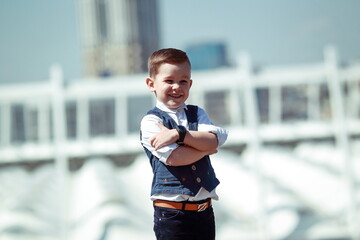 Happy Smiling Boy in Urban Location with Crossed Arms