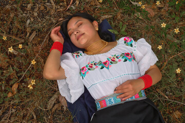 Young woman relaxing in nature surrounded by flowers
