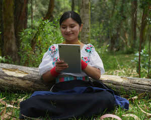 Indigenous woman using tablet in forest: embracing technology in nature
