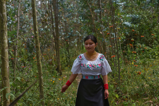 Indigenous colombian woman walking in forest touching plants - Powered by Adobe