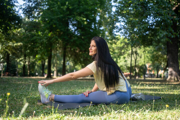 Woman, fitness and stretching legs outdoor in city for healthy body, flexible and exercise for wellness. Sports, start and runner warm up muscle to prepare for workout, training or marathon on road