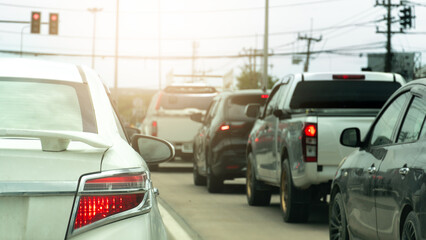 Rear side of luxury black car with turn on brake ligth. Traffic is congested with many cars queuing up.