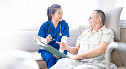 Young doctor or nurse asking senior male patient to sign insurance policy at home