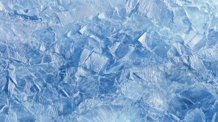Fototapeta premium A beautiful close-up showcases glimmering ice crystals forming a textured blue surface. The natural contrast enhances the vibrant hues often seen in winter landscapes.