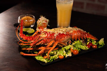 Grilled Lobster Served on Fresh Salad with Gourmet Sides
