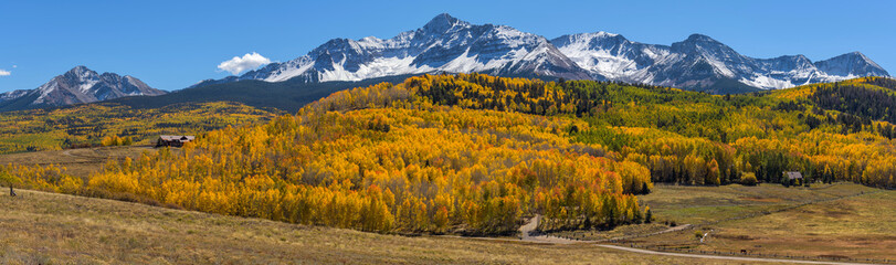 Autumn at Wilson Peak - A panoramic Autumn view of snow-capped Wilson Peak, surrounded by dense golden aspen forest. Telluride, Colorado, USA.