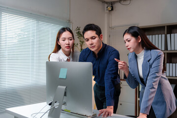 Group of young asian businesspeople having a discussion while working together in a modern office...