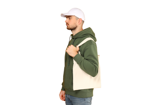 Man stands with a tote bag in a casual outfit, isolated on white, PNG