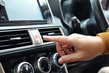Obraz premium The car's hazard lights should be turned on immediately in the event of an emergency on the road for the safety of all parties involved.
