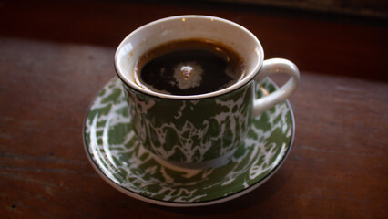 Traditional Black Coffee in Green Enamel Cup
