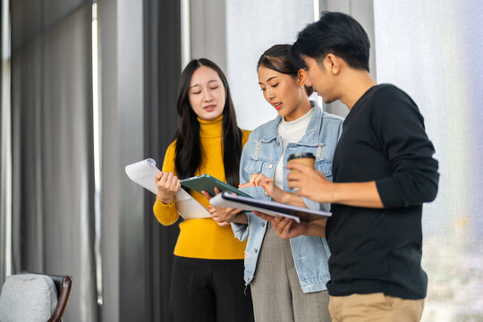 Startup creative design and production house, young asian team brainstorming ideas in coworking space collaborating on project, business branding teamwork productivity at office, professional growth