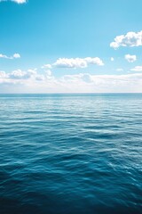 Fototapeta premium Tranquil view of calm sea against blue sky during summer