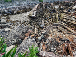 old abandoned sunken ship in the water at the ship cemetery