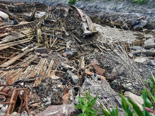 old abandoned sunken ship in the water at the ship cemetery