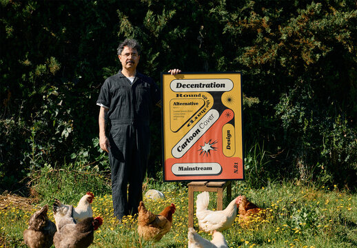 Mockup Of Man With Vertical Customized Framed Poster And Chickens