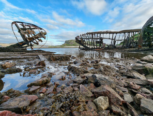 old abandoned sunken ship in the water at the ship cemetery