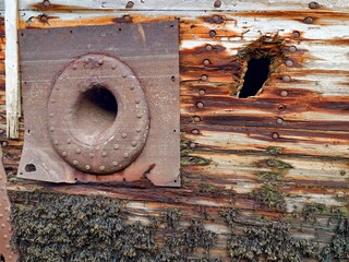 old abandoned sunken ship in the water at the ship cemetery