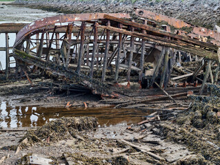 old abandoned sunken ship in the water at the ship cemetery