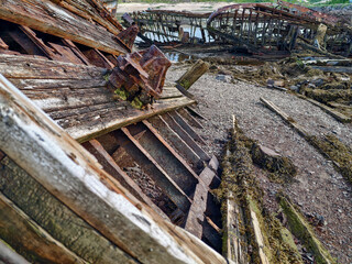 old abandoned sunken ship in the water at the ship cemetery wood pattern