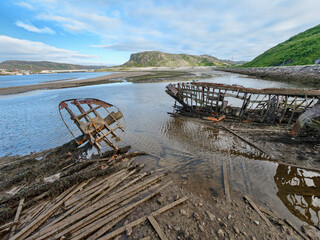 old abandoned sunken ship in the water at the ship cemetery wood pattern