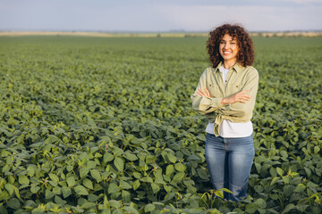 Agronomist standing in cultivated soybean field with arms crossed