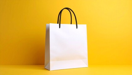 Mockup of a shopping bag with copy space for a logo displayed against a vibrant yellow background