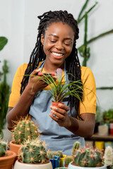Flower shop assistant cutting flowers and looking contented and happy