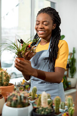 Flower shop assistant cutting flowers and looking contented and happy