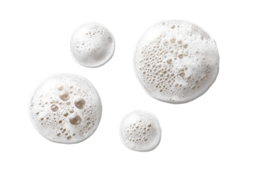 Frothy circles of foamed beverage against black