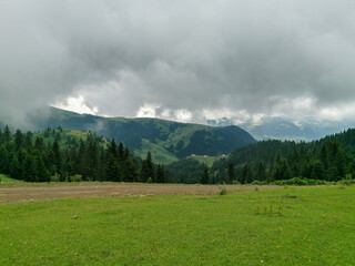 Mountain Landscape with Dramatic Clouds and Green Forest Valley