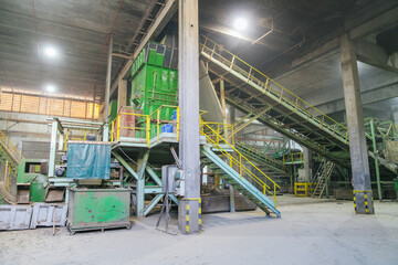 Conveyor belts transporting wood waste in a timber processing plant, creating sawdust, wood...