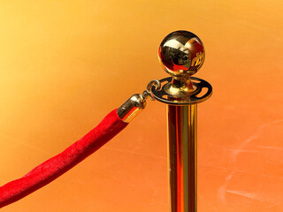 Red velvet ropes and metal stanchions at an upscale event entrance, symbolizing exclusivity, access control, and brand presentation.