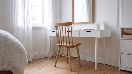A simple wooden chair sits at a white desk in a bright room