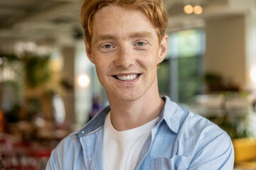 Ginger handsome young guy looking confident and positive