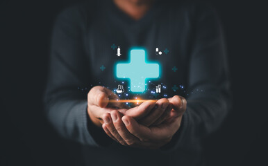 A person presents a glowing blue medical cross surrounded by healthcare icons including syringes,...
