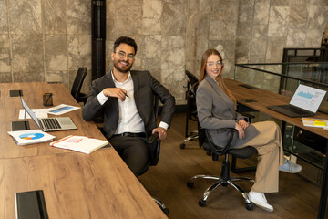 Colleagues working in the office and looking busy and involved