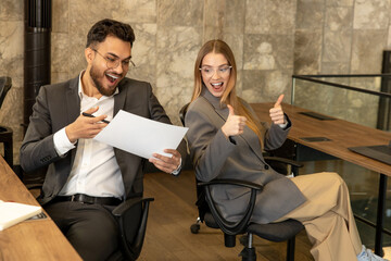 Colleagues working in the office and looking busy and involved